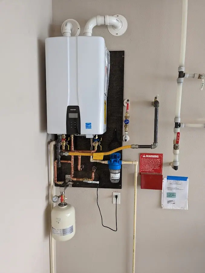 Professional plumber installing copper piping in a Calabash home